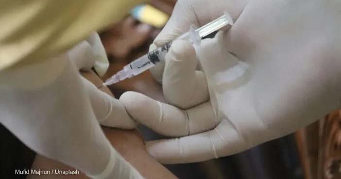A person receiving the COVID-19 vaccine. Photo by: Mufid Majnun / Unsplash